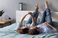 Relaxed young couple lying on bed, posing for selfie on smartphone. Royalty Free Stock Photo