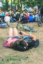 Relaxed young couple lying on grass and watching phone