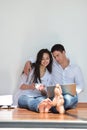 Relaxed young couple working on laptop computer at home Royalty Free Stock Photo