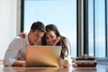 Relaxed young couple working on laptop computer at home Royalty Free Stock Photo