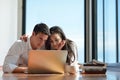 Relaxed young couple working on laptop computer at home Royalty Free Stock Photo