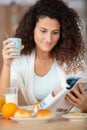 relaxed young lady reads magazine during breakfast Royalty Free Stock Photo