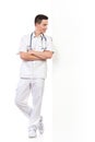 Relaxed young male nurse lean on the wall Royalty Free Stock Photo