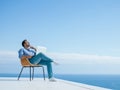 Relaxed young man at home on balcony Royalty Free Stock Photo