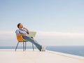 Relaxed young man at home on balcony Royalty Free Stock Photo