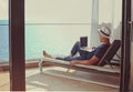 Relaxed young man at home on the balcony. Holiday and travel concept Royalty Free Stock Photo