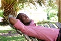 Relaxed young man lying outdoors on a hammock Royalty Free Stock Photo