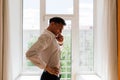 Relaxed young man resting from work. Man enjoy break stretching in home office workplace, isolation