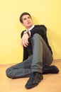 Relaxed young man sitting on the floor Royalty Free Stock Photo