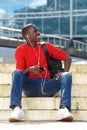 Relaxed young man sitting outdoors on steps Royalty Free Stock Photo