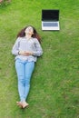 Relaxed young person (teenage girl) lying in grass Royalty Free Stock Photo