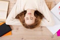 Relaxed young student woman lying on the floor Royalty Free Stock Photo