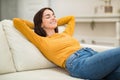 Relaxed young woman chilling on couch at home Royalty Free Stock Photo