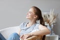 Relaxed young woman on cozy chair with eyes shut closed. Enjoying at home Royalty Free Stock Photo