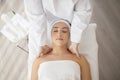 Relaxed young woman having neck massage in aroma spa wellness center Royalty Free Stock Photo