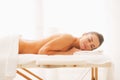 Relaxed young woman laying on massage table Royalty Free Stock Photo