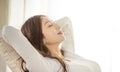 Relaxed young woman leaned on couch and closed eyes