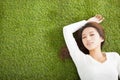 Relaxed young woman lying on the grass