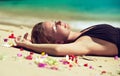 Relaxed young woman lying on the sand. Royalty Free Stock Photo