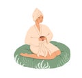 Relaxed young woman resting with tea in Spa and Wellness center. Female character in gown and bath towel sitting in