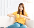 Relaxed young woman siiting on the sofa at home