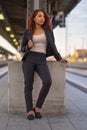 Relaxed young woman standing waiting for a train