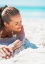 Relaxed young woman in swimsuit laying on beach Royalty Free Stock Photo