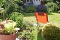 Relaxing area in garden with a deck chair on the lawn during a sunny day