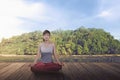 Relaxing asian girl doing yoga in lotus position Royalty Free Stock Photo