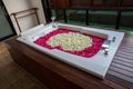 A relaxing bath with rose. bath tub with floating petals. Rose petals put in bathtub for romantic bathroom in honeymoon suit. Royalty Free Stock Photo