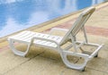 Relaxing beach chair beside of blue swimming pool