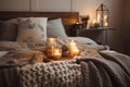 relaxing bedroom that is hygge-inspired with cozy bedding, flannel blanket and candle light