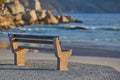 Relaxing bench with sea or ocean view to enjoy calm, peaceful and zen nature with waves washing on shore in a remote Royalty Free Stock Photo