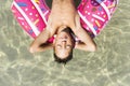 Cute boy with inflatable donut in swimming pool Royalty Free Stock Photo