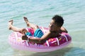 Child with inflatable ring in sea