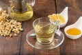 Relaxing chamomile tea in glass cup with lemon slices and honey next to it on wooden table Royalty Free Stock Photo