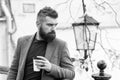 Relaxing coffee break. Hipster hold paper coffee cup and enjoy park environment. Drink it on the go. Man bearded hipster Royalty Free Stock Photo