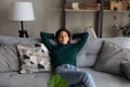 Calm hispanic woman take break for nap on soft couch Royalty Free Stock Photo