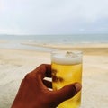 On a relaxing day, have a cold beer on the table in the restaurant by the sea.