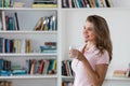 Relaxing and dreming woman with cup of water Royalty Free Stock Photo