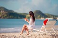 Relaxing and enjoying on summer vacation, woman lying on sunbed on beach