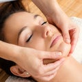 Relaxing facial massage on female chin. Royalty Free Stock Photo