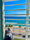 Hotel window beach view feet resting Fort Lauderdale Florida Royalty Free Stock Photo