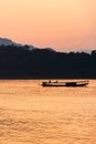 Relaxing on ferryboat on the Mekong River at dusk