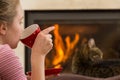 Relaxing By Fireplace with Drink and cat Royalty Free Stock Photo