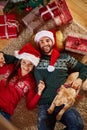 Relaxing on floor with Christmas gifts Royalty Free Stock Photo