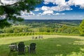 Relaxing green field and open valley under blue summer sky Royalty Free Stock Photo