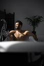 Relaxing handsome man with beard in bathtub