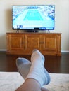 Relaxing at home by watching tennis on televison