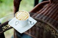 Relaxing with hot caramel cappuccino coffee Serve in white cup in garden Royalty Free Stock Photo